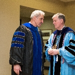 President Emeritus Haas and faculty member having a discussion